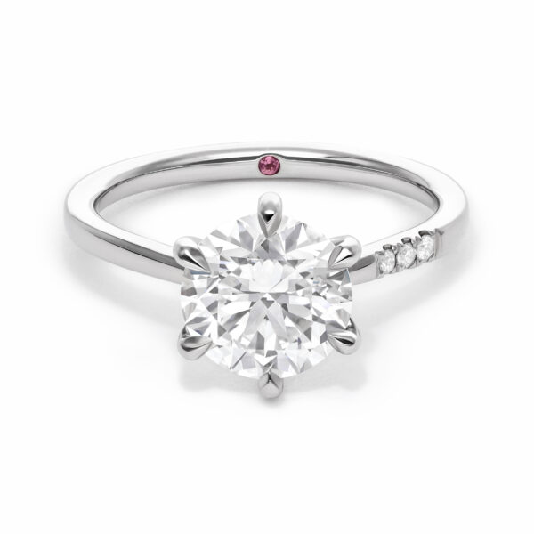 custom-asymmetric-platinum-engagement-ring-with-six-claw-set-round-diamond-and-one-side-of-pave-diamonds-on-the-band