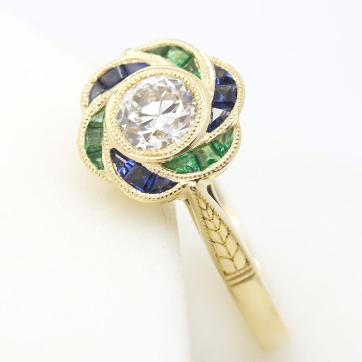 Emerald and blue sapphire custom cut floral hand engraved organic engagement ring